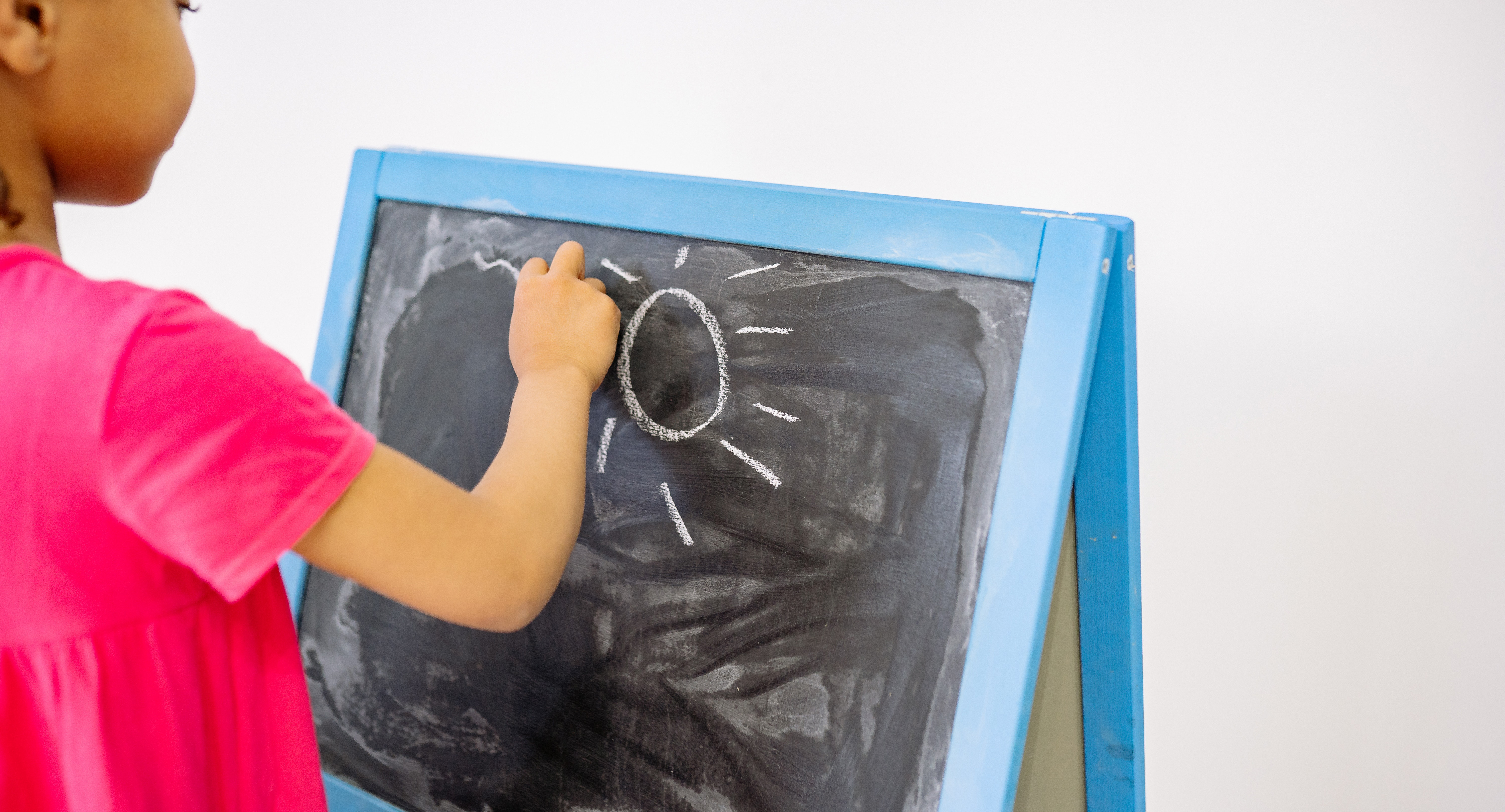 Image of a girl drawing on a chalkboard
